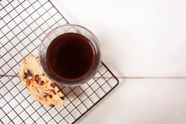 Italian biscotti on the baking rack and glass of coffee.