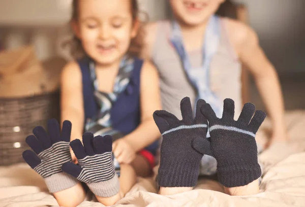 快乐的童年可爱的女孩和男孩玩的很时尚 脚上戴着手套 可爱的孩子们在室内玩得很开心 隔离的乐趣 — 图库照片
