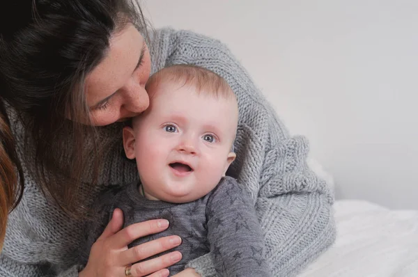 Madre besando hijo recién nacido en casa — Foto de Stock