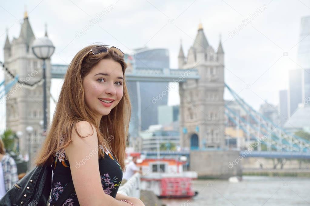 Portrait of a girl with Tower Bridge on background in London