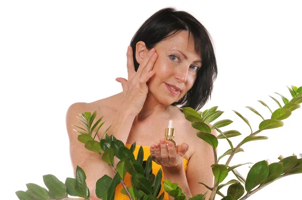 Mature woman doing rejuvenation spa procedure for face — Stock Photo, Image