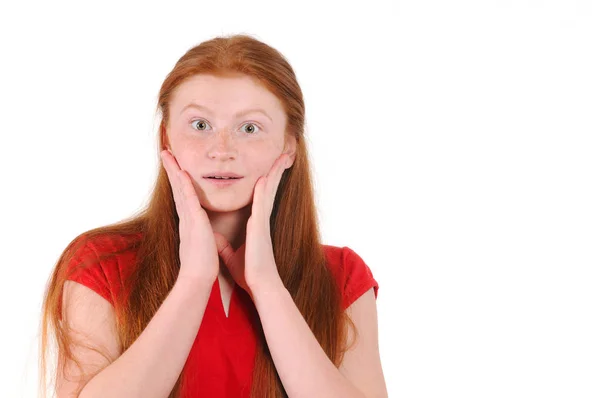 Red hair teenager girl in a red shirt showing a sincere surprise — Stock Photo, Image