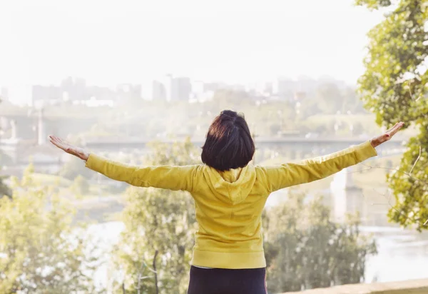 Joyful woman breathing fresh air outdoors Stock Image