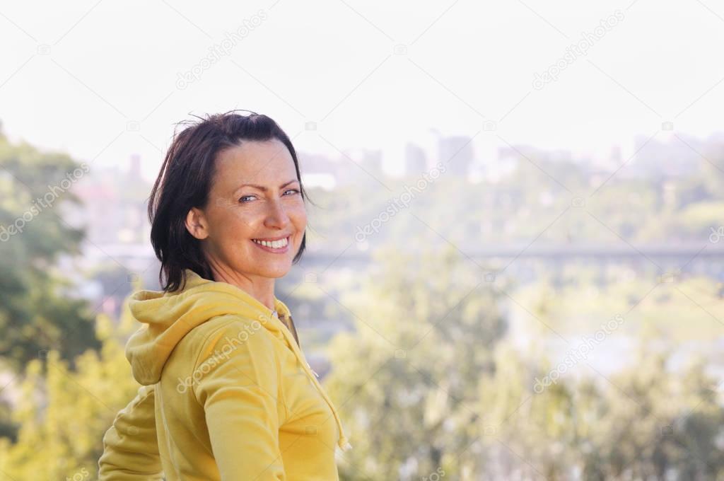 Portrait of mature woman weared in sports clothes in the park