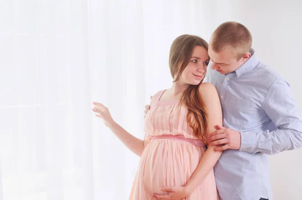 Pregnancy and lovely couple at home — Stock Photo, Image