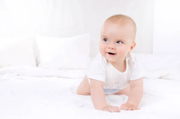 Adorable baby boy in white sunny bedroom — Stock Photo, Image