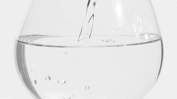 Pour a half filled glass of water full — Stock Video