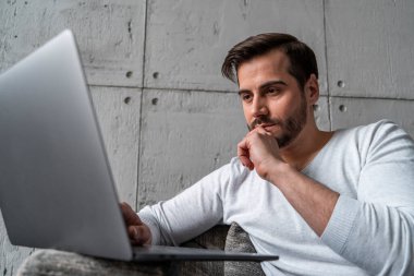 Koltukta dizüstü bilgisayarda yazan ciddi programcı