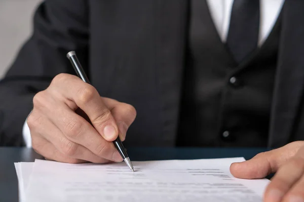 Close up of businessman in tie signing contract Stock Image