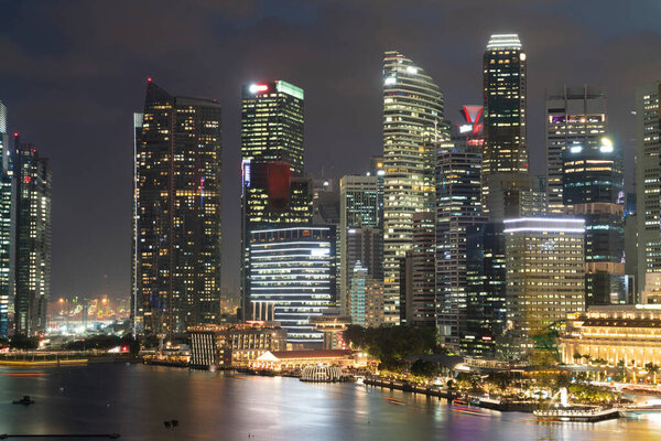 Picturesque panoramic view of Singapore city at night time. Financial and trading center hub in Asia region. Concept of success. Modern buildings in high-tech world.