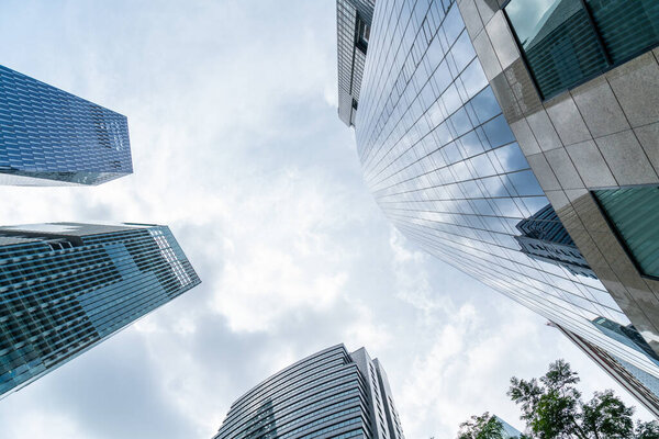 Low-angle view of picturesque skyscrapers of Singapore city downtown at day time. Financial district and trading center hub in Asia region. Concept of success. Modern buildings in high-tech world.