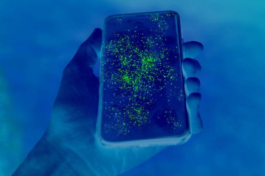 Yeşil kontrastlı görünmeyen mikroplarla kirli cep telefonu ekranı
