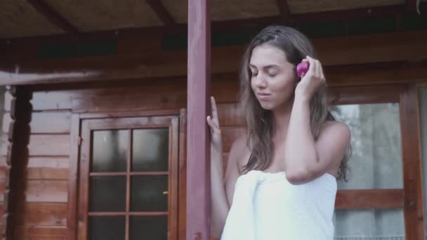 Beautiful Girl Puts Pink Flower Her Ear She Dressed White — Stock Video