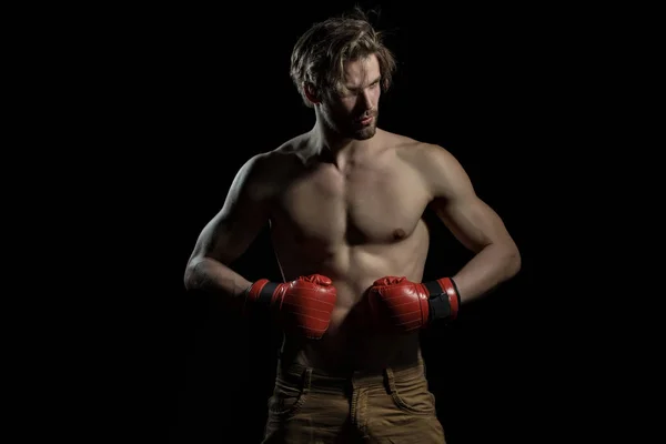 Un uomo serio con i guanti da boxe. Boxer pensa. Ritratto di pugile in posa in studio in guanti da boxe rossi — Foto Stock