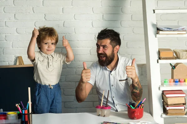 Family thumbs up. Father and little cute son show thumbs up, success on home education. Good hand, good job, show thump up for agreement sign success business art concept. Children learning success