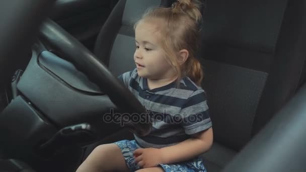 Turn, car signal. Boy driver turns on the right. Trip by car, boy is played in front seat. Safety on the road. Rules of the road traffic. Fast road, highway — Stock Video