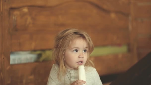 Child Drinks Yogurt Cute Boy Long Hair Eating Breakfast Dairy — Stock Video