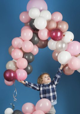 Kapalı izole balonlar ile mutlu bir çocuk. Eğlenceli parti çocuğu. Çocuk mutluluk kavramı. Gökkuşağı balonları Toddler doğum günü partisinde. Neşeli çocuk var eğlenceli ve sevinç, hayattan zevk
