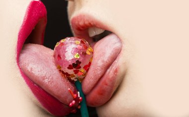 Beautiful female lovers kissing with tongues out. Sweet tasty candy for lesbians, LGBT couple. Dessert for two. Close best girlfriend. Sexy kiss with candy. Beautiful attractive girls. Protection clipart