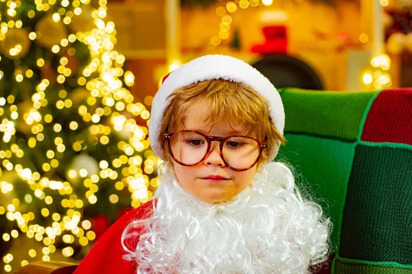 Sad Santa Claus. Childrens emotions. The boy misses his parents. Emotions. Glasses for children.