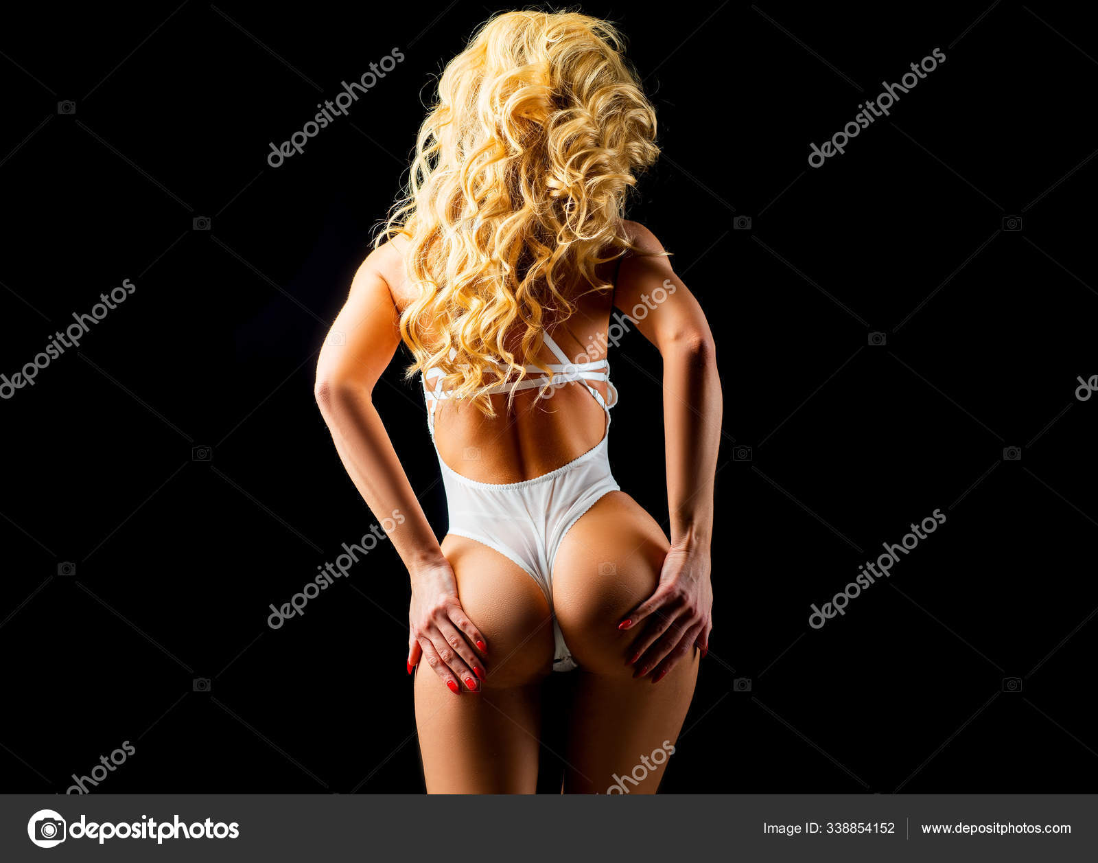 Female sexy buttocks in white panties over black background. Back view of perfect female legs and buttocks. Beautiful athletic female ass in underwear picture picture