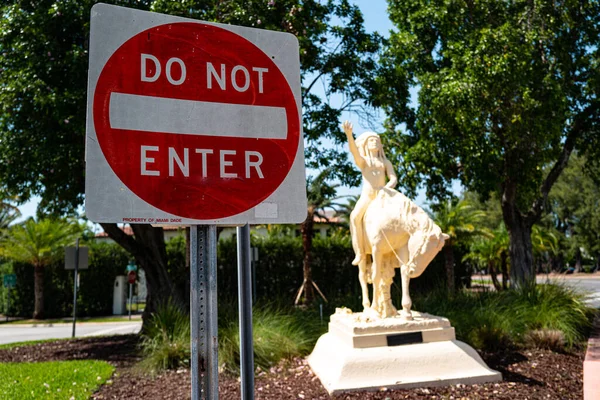 Miami Beach, Florida, USA - May 21, 2020: Do not enter road sign and Indian Statue Miami Beach. Indigenous people of the USA. Native Americans or American Indians.