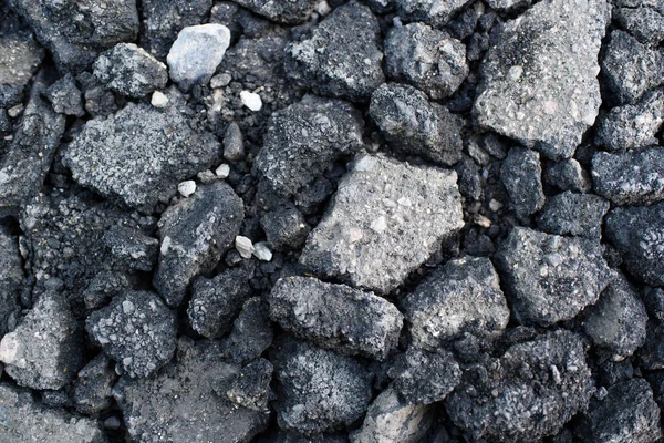 Pieces of asphalt pavement in the hole in the road