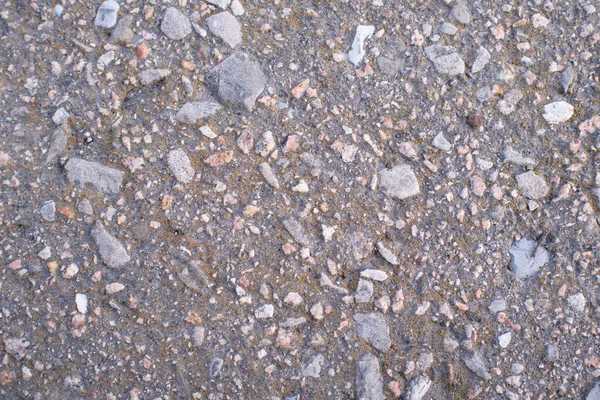 Ground stone gray background of a large number of small stones