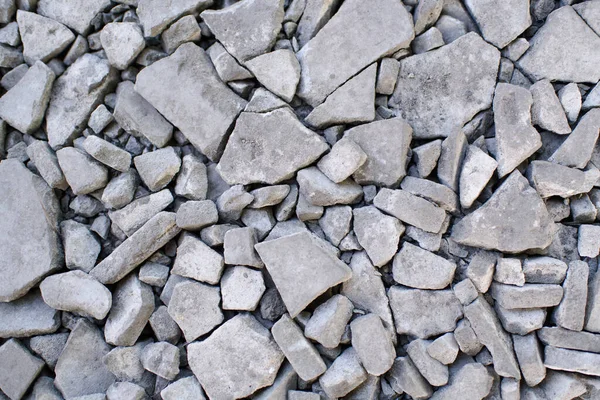 Ground stone gray background of a large number of small stones