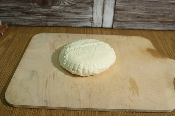 Fresh Adyghe cheese on a wooden tray on a wooden background — Stock Image Fresh Adyghe Cheese Wooden Tray Wooden Background Royalty Free Stock Images