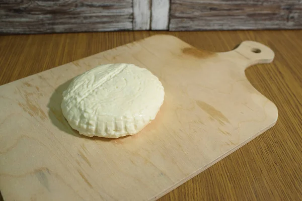 Fresh Adyghe cheese on a wooden tray on a wooden background — Stock Image Fresh Adyghe Cheese Wooden Tray Wooden Background Royalty Free Stock Photos