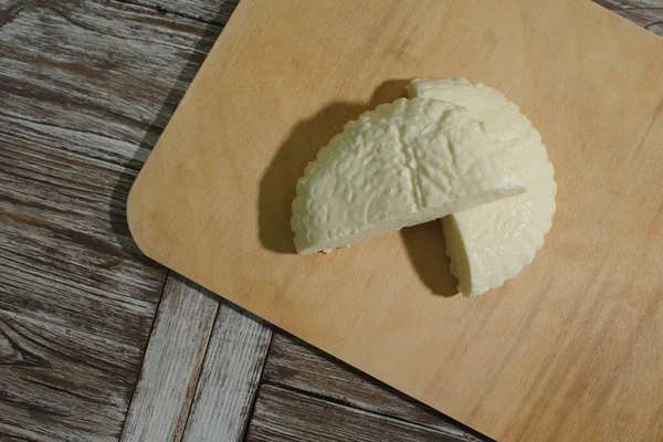 Fresh Adyghe cheese on a wooden tray on a wooden background — Stock Image Fresh Adyghe Cheese Wooden Tray Wooden Background Stock Photo