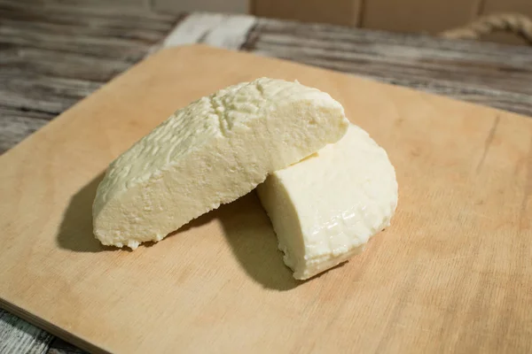 Fresh Adyghe cheese on a wooden tray on a wooden background — Stock Image Fresh Adyghe Cheese Wooden Tray Wooden Background Royalty Free Stock Images