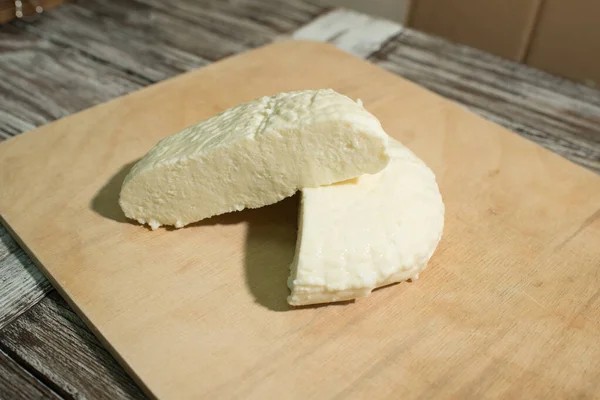 Fresh Adyghe cheese on a wooden tray on a wooden background — Stock Image Fresh Adyghe Cheese Wooden Tray Wooden Background Royalty Free Stock Photos