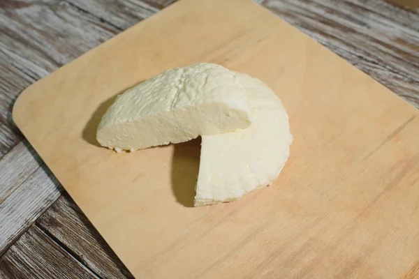 Fresh Adyghe cheese on a wooden tray on a wooden background — Stock Image Fresh Adyghe Cheese Wooden Tray Wooden Background Royalty Free Stock Photos