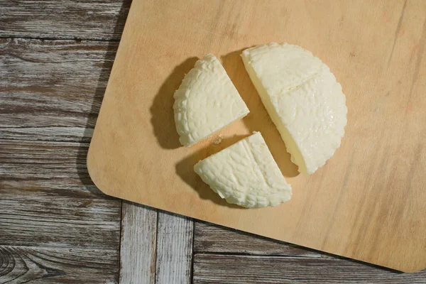 Fresh Adyghe cheese on a wooden tray on a wooden background — Stock Image Fresh Adyghe Cheese Wooden Tray Wooden Background Stock Image