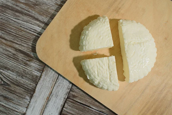 Fresh Adyghe cheese on a wooden tray on a wooden background — Stock Image Fresh Adyghe Cheese Wooden Tray Wooden Background Stock Image