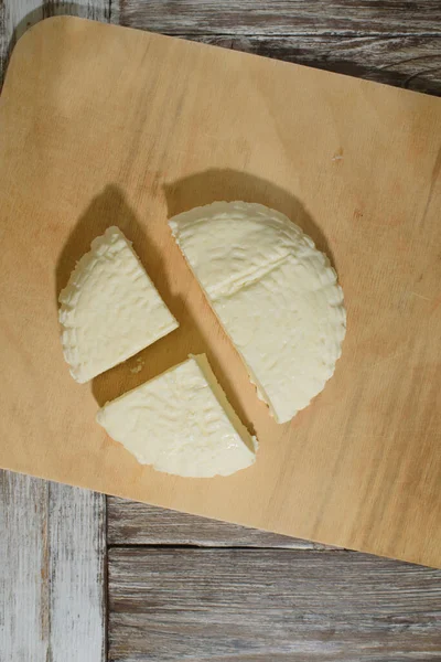 Fresh Adyghe cheese on a wooden tray on a wooden background — Stock Image Fresh Adyghe Cheese Wooden Tray Wooden Background Royalty Free Stock Photos