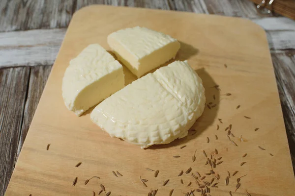 Fresh Adyghe cheese on a wooden tray on a wooden background — Stock Image Fresh Adyghe Cheese Wooden Tray Wooden Background Stock Picture