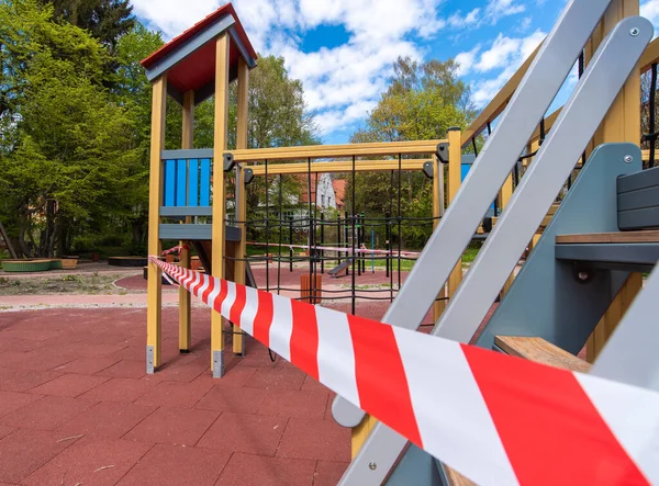 The children's Playground is closed for quarantine with tape.