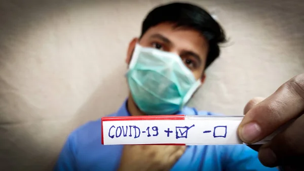 Covid corona virus patient test positive result man face wear face mask, selective focus , blurred background.