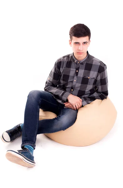 Man with angry face sit in big soft chair isolated — Stock Photo, Image