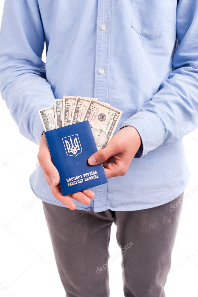 Hands holding passport with money isolated