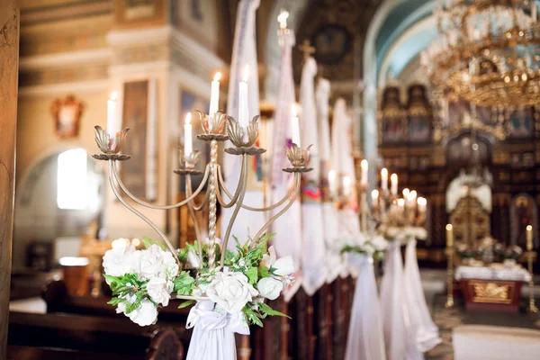 Candel holder in church decorated for wedding ceremony