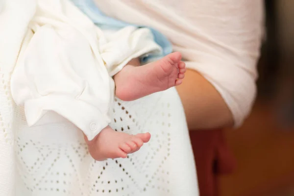 Cute little feet on white blanket in church — Stock Photo, Image