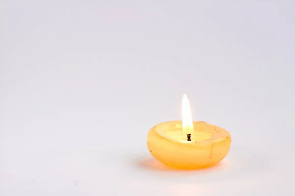 burning candle on white background