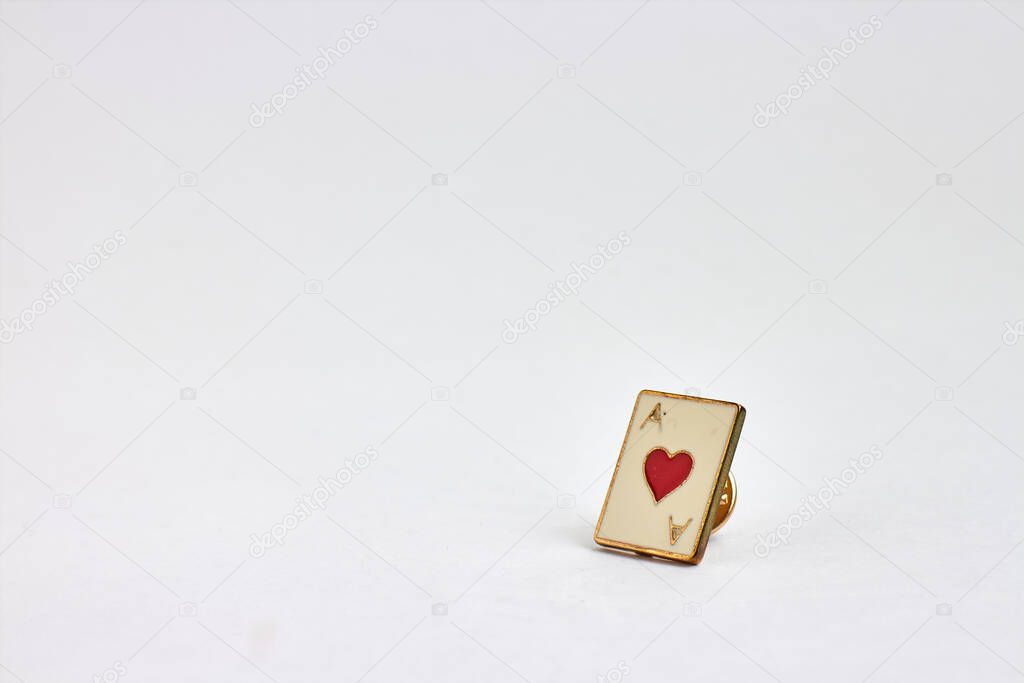 brooch with ace of hearts on white background