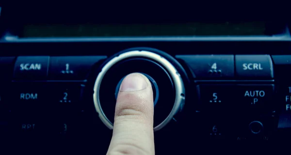 finger push power button in car