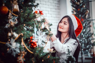 Gülümse kadın Noel ağacını süslüyor 