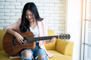 Kanepede gitar çalan kadın. .